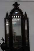 A LARGE CARVED GOTHIC STYLE OVERMANTLE MIRROR
