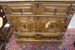 AN OAK AND WALNUT GEOMETRIC PANEL THREE DRAWER CHEST