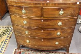A REGENCY MAHOGANY AND INLAID BOW FRONT CHEST OF DRAWERS