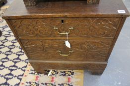 A SMALL CARVED OAK TWO DRAWER CHEST