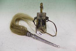 AN EASTERN WHITE METAL MOUNTED FLY WHISK AND A POWDER FLASK.