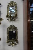 A PAIR OF CAST BRASS THREE LIGHT WALL SCONCES WITH MIRROR BACKS