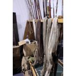 AN INTERESTING COLLECTION OF VARIOUS VINTAGE SPLIT CANE AND OTHER FISHING RODS, NUMEROUS FISHING