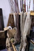 AN INTERESTING COLLECTION OF VARIOUS VINTAGE SPLIT CANE AND OTHER FISHING RODS, NUMEROUS FISHING