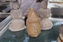 A PAIR OF CARVED MARBLE ORIENTAL FIGURES OF KNEELING DEITIES AND A CARVED STONE HEAD.