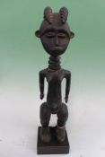 A CARVED AFRICAN CEREMONIAL TRIBAL FIGURE