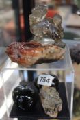 A GROUP OF HARDSTONE CARVINGS TO INCLUDE A MYTHICAL BEAST AND TWO TIGER'S EYE EGGS.