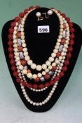 THREE STRINGS OF ANTIQUE IVORY BEADS, A STRING OF ORIENTAL CINNIBAR LACQUER BEADS, A PAIR OF