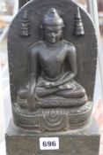 AN EARLY INDIAN CARVED STONE FIGURE OF A SEATED BUDDHA