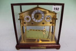 A GOOD QUALITY GILT BRASS CONGREAVE ROLLING BALL DESK CLOCK
 
appears in excellent condition