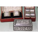 A CASED SET OF FOUR HALLMARKED SILVER NAPKIN RINGS, A FURTHER CASED PAIR AND AN EASTERN WHITE