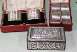 A CASED SET OF FOUR HALLMARKED SILVER NAPKIN RINGS, A FURTHER CASED PAIR AND AN EASTERN WHITE