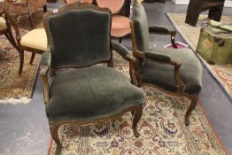 A PAIR OF CONTINENTAL WALNUT FRAMED OPEN ARMCHAIRS