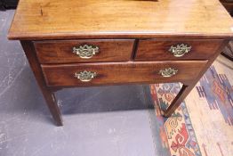 A GEORGIAN MAHOGANY THREE DRAWER SIDE TABLE ON SQUARE CHAMFERED LEGS