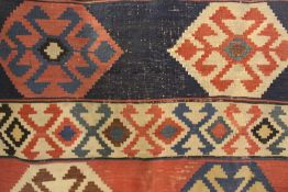 AN ANTIQUE CAUCASIAN KELIM RUG MADE UP OF TWO MATCHING PANELS.