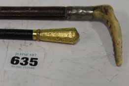 A 19TH.C.YELLOW METAL MOUNTED RIDING CROP AND A CHILD'S SILVER MOUNTED RIDING CROP.