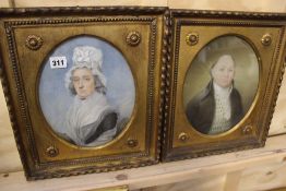 A PAIR OF 19TH.C.WATERCOLOUR PORTRAITS OF A LADY AND GENTLEMAN IN MATCHING FRAMES