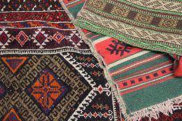 A BELOUCH PRAYER RUG AND FOUR TRIBAL FLAT WEAVE PANELS.