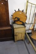 AN ANTIQUE KNIFE POLISHER TOGETHER WITH A PINE FRIDGE CABINET.