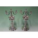 A PAIR OF WHITE METAL CANDLESTICKS WITH HALLMARKED SILVER THREE LIGHT BRANCHES
