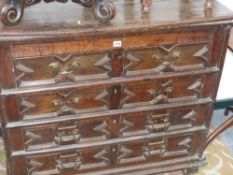 An early chest of drawers with rising top and recess