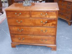 A late Georgian fruitwood chest of two short and three long graduated drawers