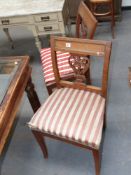 A set of four continental Empire oak and brass mounted side chairs