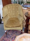 An antique George II style wingback armchair together with a Victorian barrel back armchair