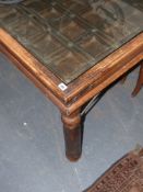 A large colonial dining table with inset glass top