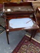 An Edwardian mahogany folding writing table with fitted interior