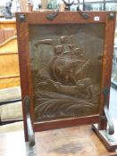 An Arts and Crafts oak framed copper firescreen