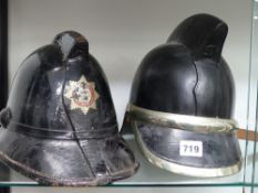 A vintage English hard leather fireman's helmet together with another with nickel mounts