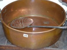 A large antique copper pan and a skimmer