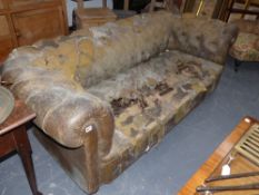 A large leather upholstered Chesterfield settee for re upholstery