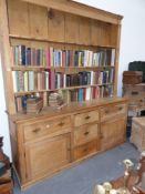 A large Victorian pine kitchen dresser and plate rack