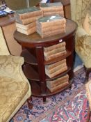 A 19th Century Mahogany library bookcase stand of oval form with leather inset top