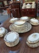 An extensive late 19th Century Wedgwood dinner service. Foliate scroll borders with gilt accents