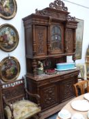 A French walnut buffet cabinet with raised cabinet over marble top and cupboards below