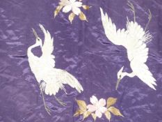 An Oriental silkwork panel decorated with birds and flowers