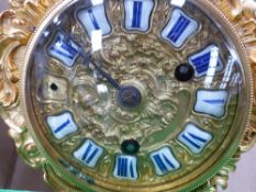 A Victorian gilt bronze mounted mantle clock with enamelled numeral dial and striking French