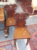 A pair of Victorian mahogany hall chairs