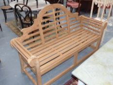 A pair of Teak garden benches in the manner of Lutyens