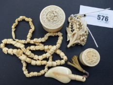 A small group of carved ivory pieces to include a necklace of skull form beads, two oriental pill