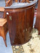 A late Geo.III mahogany bow front corner cabinet