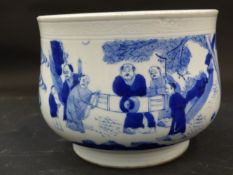 A Chinese blue and white deep bowl decorated with figures in a landscape