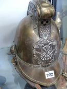 An Antique brass Merry Weather pattern fireman's helmet with STD issue badge and chain chin strap