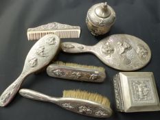 An Indian/Asian Colonial group of seven dresser pieces to include a hand mirror, brushes, box etc.