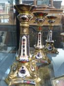 A set of six Royal Crown Derby candlesticks. Shaped square bases with dolphin corners. Gilt and