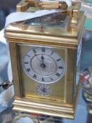 An Edwardian gilt brass cased carriage clock with alarm