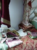 A collection of various curtains, cushions, pieces of fabric etc